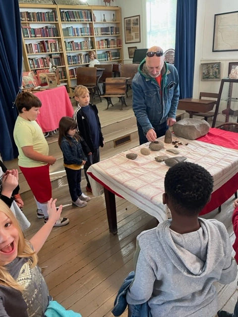 Rob Jacoby showing children stone artifacts